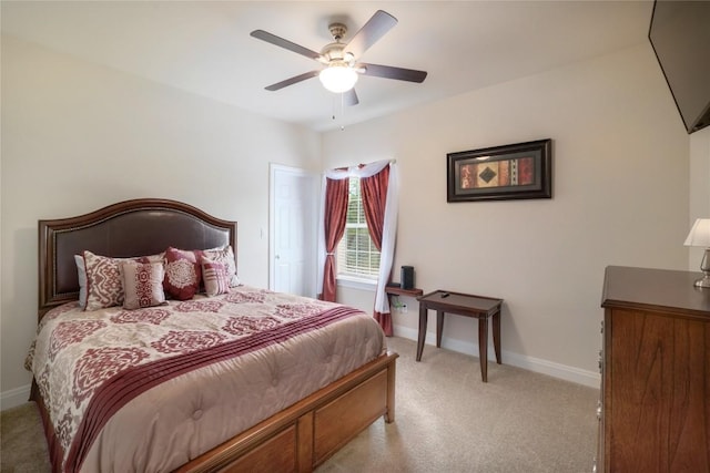 bedroom with baseboards, a ceiling fan, and light colored carpet