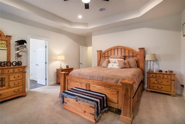 bedroom with baseboards, visible vents, a raised ceiling, carpet floors, and recessed lighting