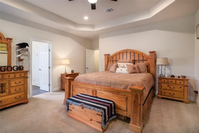 254 Cardinal Loop, Paige, TX 78659 - carpeted bedroom with a raised ceiling, ensuite bath, and a ceiling fan
