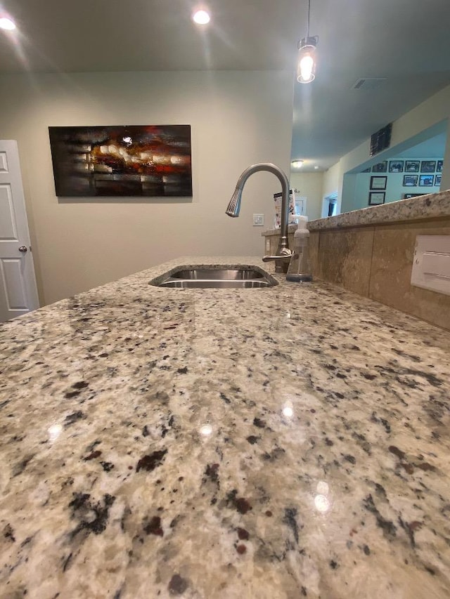 254 Cardinal Loop, Paige, TX 78659 - kitchen with light stone counters, recessed lighting, and pendant lighting