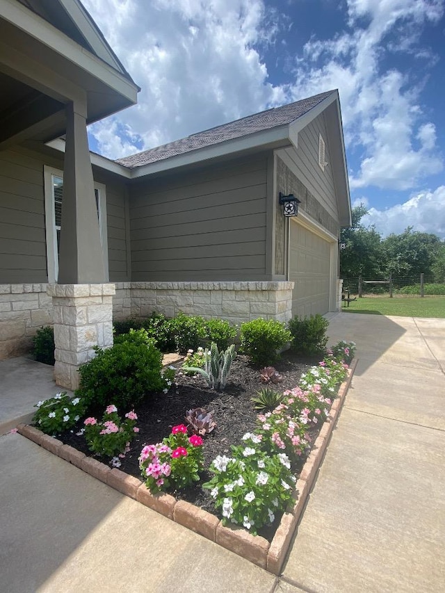 254 Cardinal Loop, Paige, TX 78659 - view of side of property with a garage and driveway