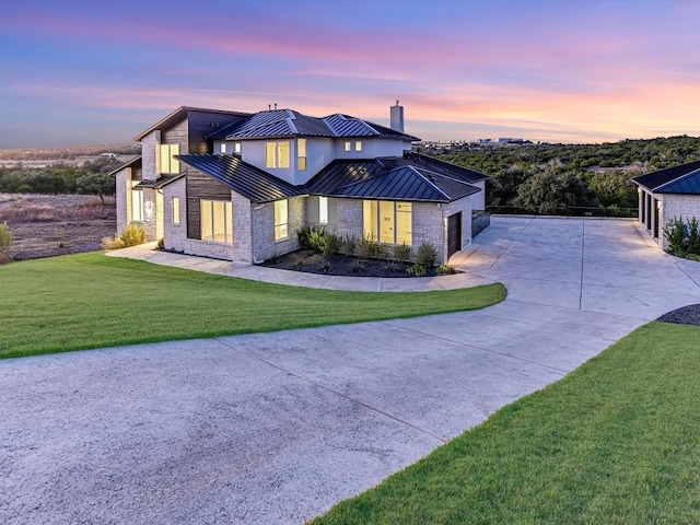 view of front of house with a garage and a lawn