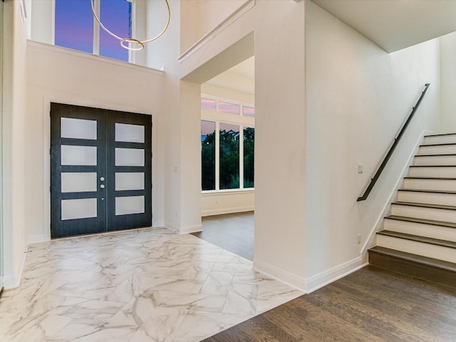 foyer entrance featuring a high ceiling and french doors