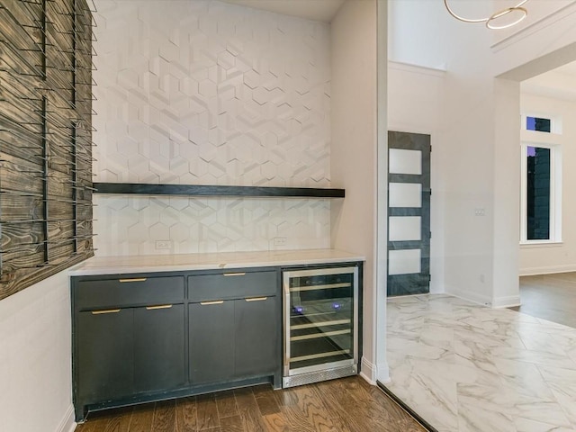 bar with wine cooler, backsplash, gray cabinetry, and dark hardwood / wood-style floors