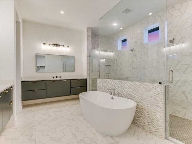 bathroom featuring vanity and separate shower and tub