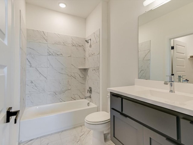 full bathroom with tiled shower / bath, vanity, and toilet