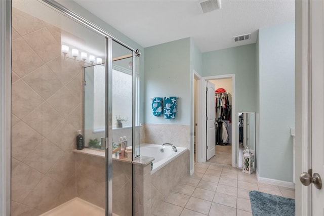 19405 Colgin Dr, Pflugerville, TX 78660 - bathroom with tile patterned floors, a shower stall, a bath, and a spacious closet