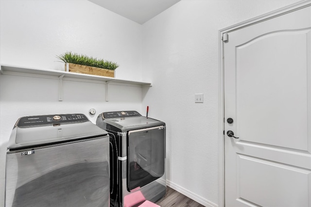 laundry area with wood-type flooring and washer and dryer