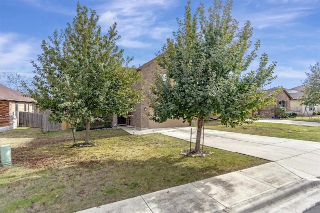 view of property hidden behind natural elements with a front yard