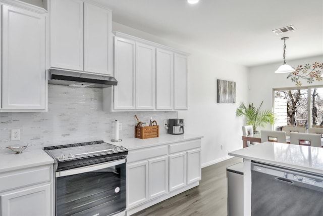 kitchen with decorative backsplash, black dishwasher, stainless steel electric range, and white cabinets