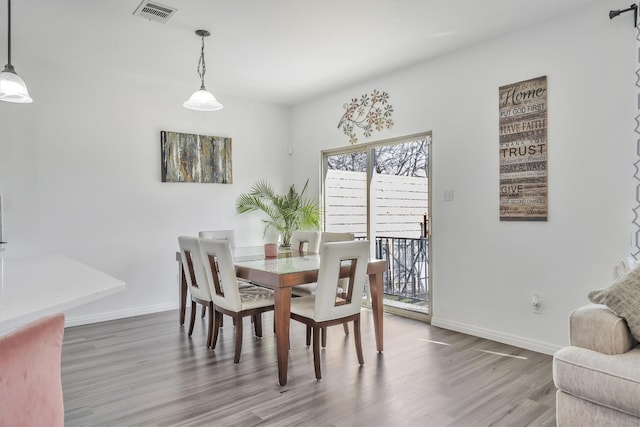 dining space featuring wood-type flooring