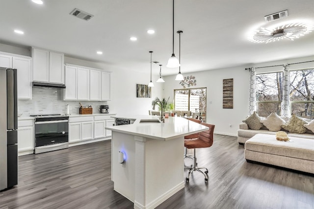 kitchen featuring pendant lighting, sink, appliances with stainless steel finishes, a kitchen island with sink, and white cabinetry