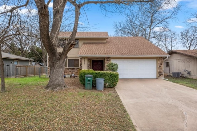 view of front of home featuring a garage, central AC, and a front lawn