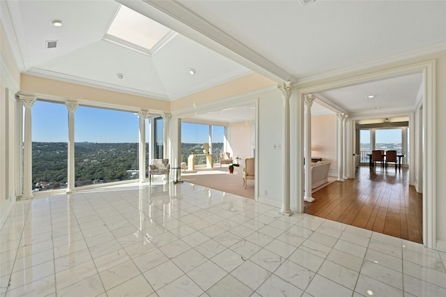 tiled spare room with crown molding and lofted ceiling with skylight