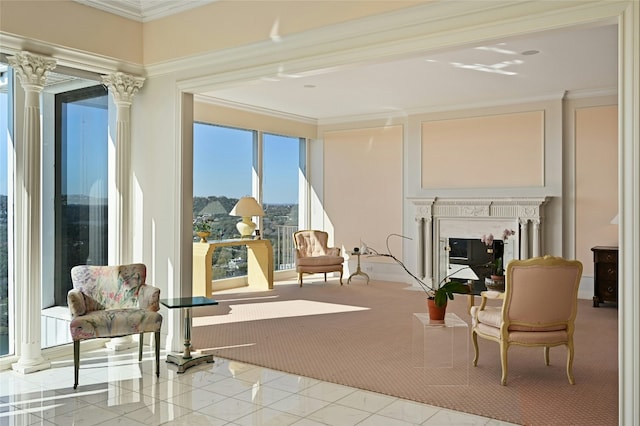 living area featuring light tile patterned flooring, ornamental molding, a premium fireplace, and ornate columns