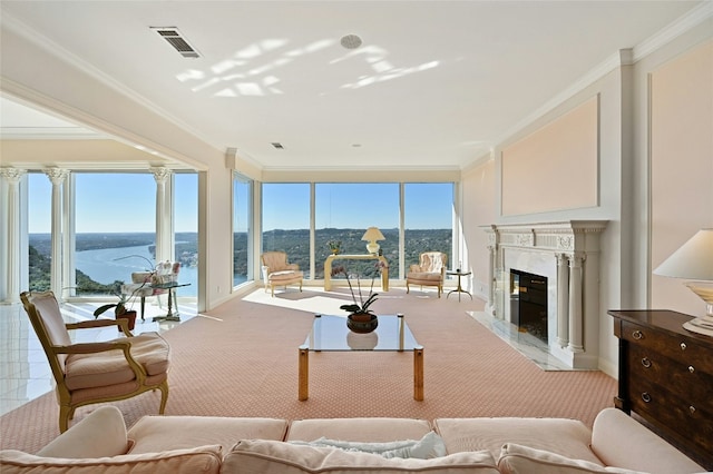 living room featuring a water view, ornamental molding, and a premium fireplace