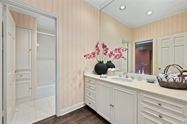 bathroom featuring crown molding, vanity,  shower combination, and hardwood / wood-style flooring