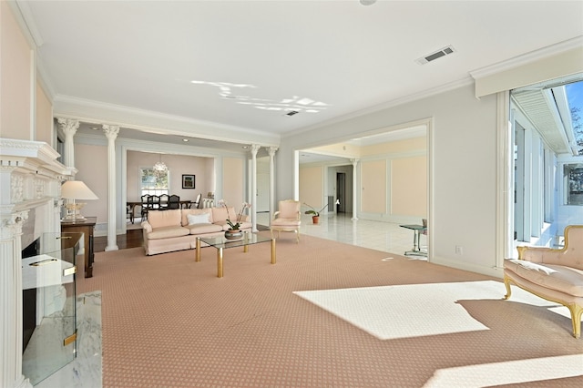 living room with a high end fireplace, ornamental molding, and decorative columns