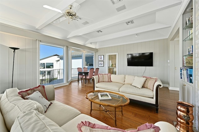 living room featuring ceiling fan, dark hardwood / wood-style floors, and beam ceiling