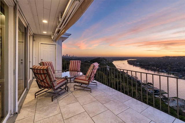 balcony at dusk with a water view