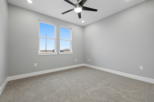 carpeted spare room with ceiling fan