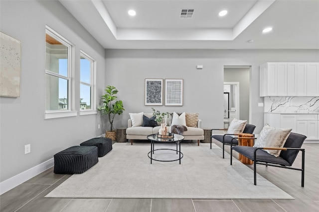 living room featuring a raised ceiling