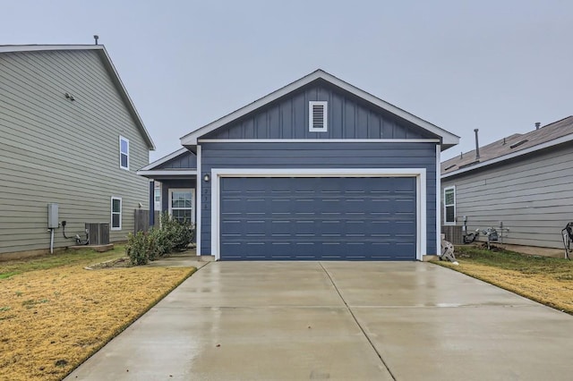 view of front of house featuring a garage and central air condition unit