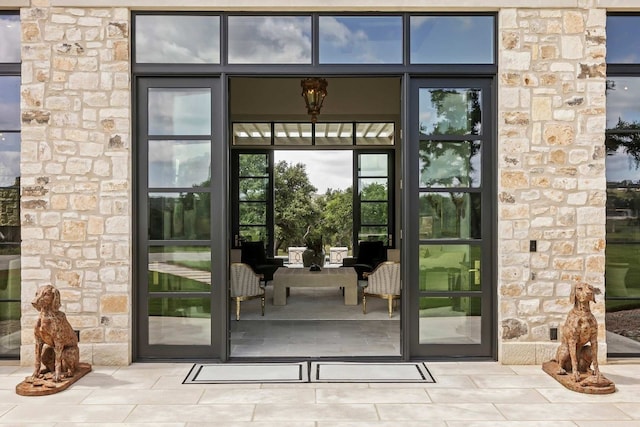 view of exterior entry featuring stone siding