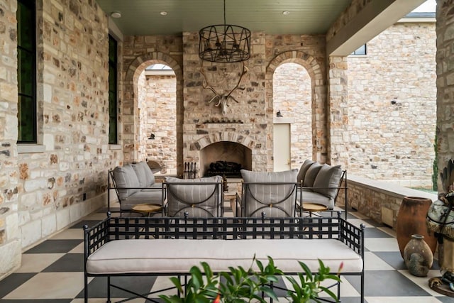 view of patio / terrace with an outdoor living space with a fireplace