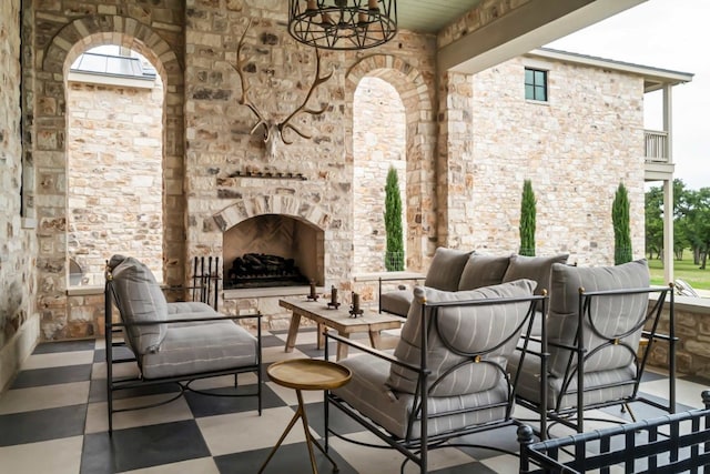 view of patio with an outdoor living space with a fireplace