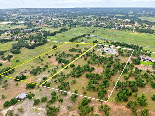 birds eye view of property with a rural view