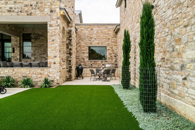 back of property with a lawn and a patio