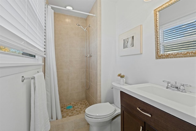 bathroom featuring toilet, vanity, and walk in shower