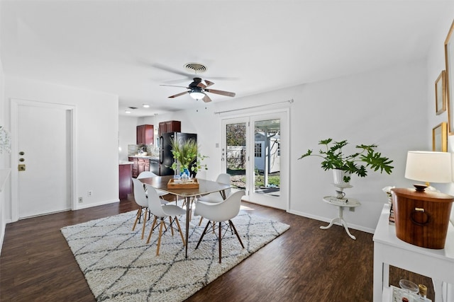 dining space with dark wood-type flooring and ceiling fan