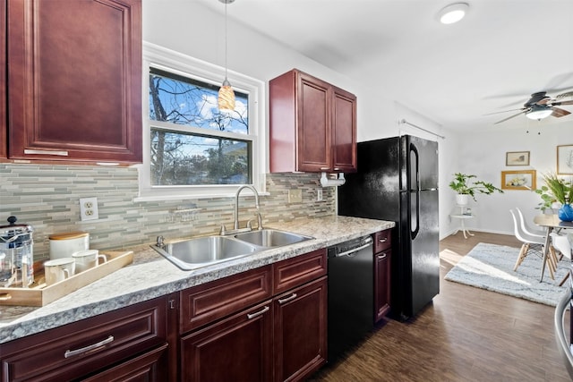 kitchen with decorative light fixtures, black appliances, sink, ceiling fan, and dark hardwood / wood-style floors