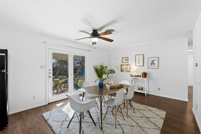 dining space with ceiling fan and dark wood-type flooring