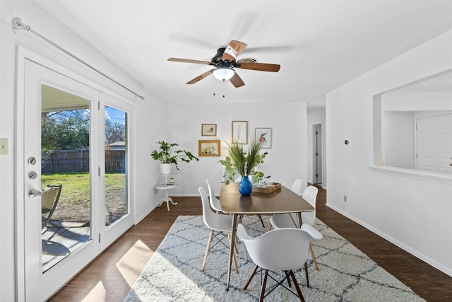 dining space featuring ceiling fan and dark wood-type flooring