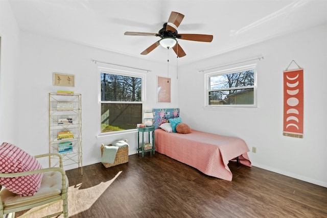 bedroom with dark wood-type flooring and ceiling fan