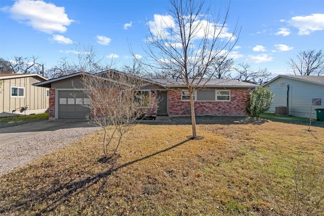 ranch-style home featuring a garage, central AC unit, and a front yard