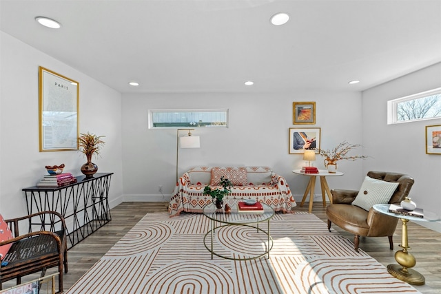 living area with recessed lighting, baseboards, and wood finished floors