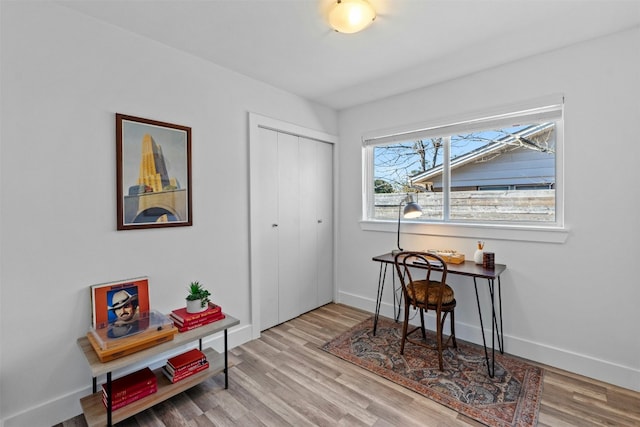 interior space featuring baseboards and wood finished floors