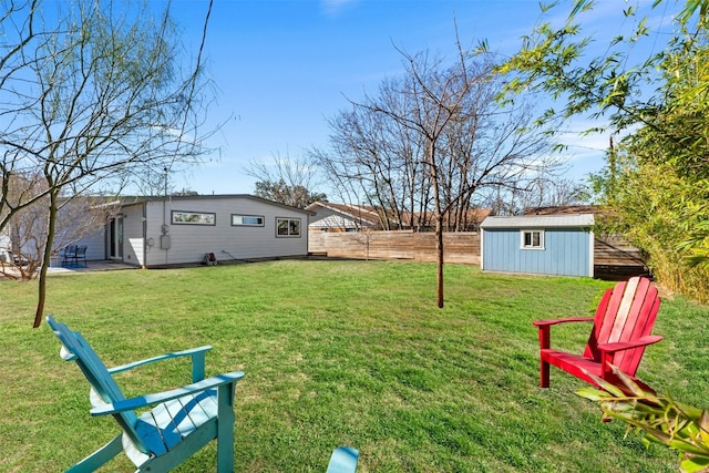 view of yard with an outbuilding and a fenced backyard