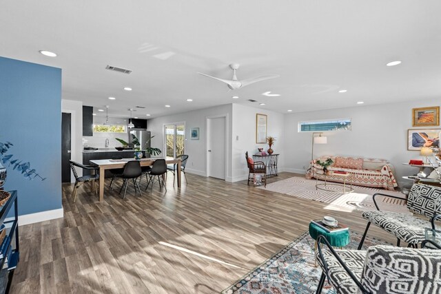 living room with wood-type flooring and ceiling fan