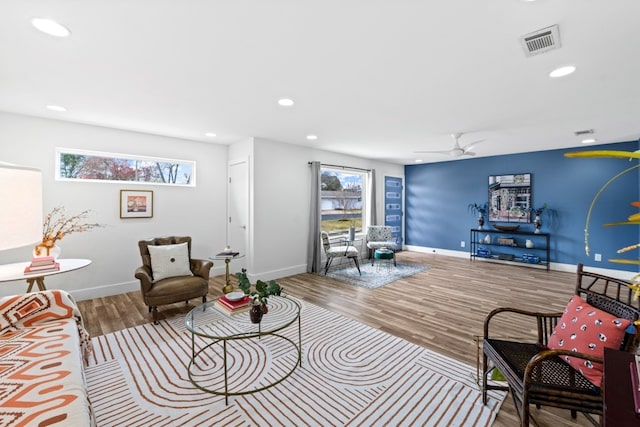 living room featuring recessed lighting, visible vents, plenty of natural light, and wood finished floors