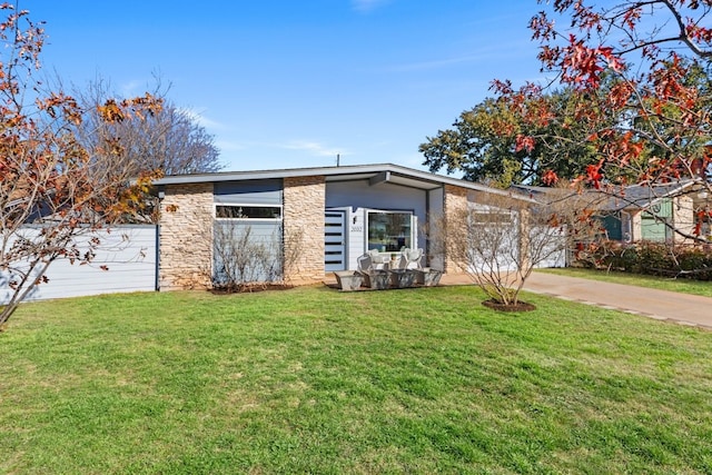 ranch-style home with a garage and a front yard