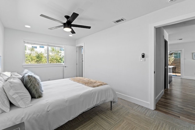 bedroom with ceiling fan and wood-type flooring