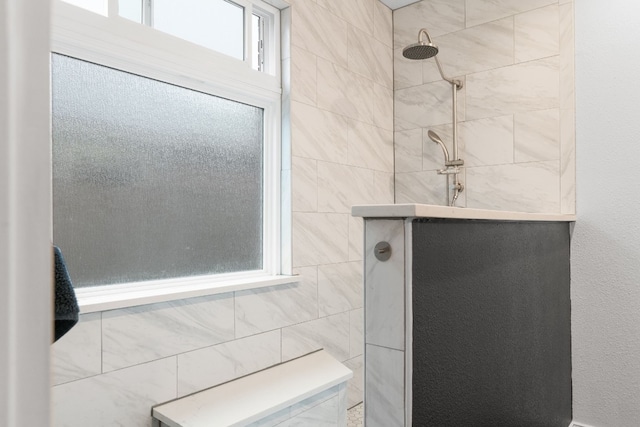 bathroom with tiled shower