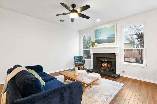 6136 Oliver Loving Trl, Austin, TX 78749 - living area featuring ceiling fan, a fireplace, wood finished floors, and recessed lighting