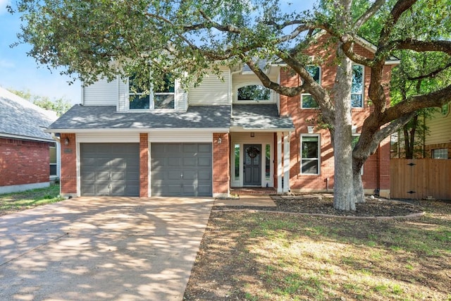 6136 Oliver Loving Trl, Austin, TX 78749 - view of front facade with driveway, a garage, brick siding, and a shingled roof