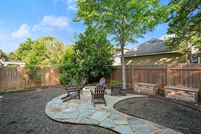 6136 Oliver Loving Trl, Austin, TX 78749 - fenced backyard with an outdoor fire pit and a patio area